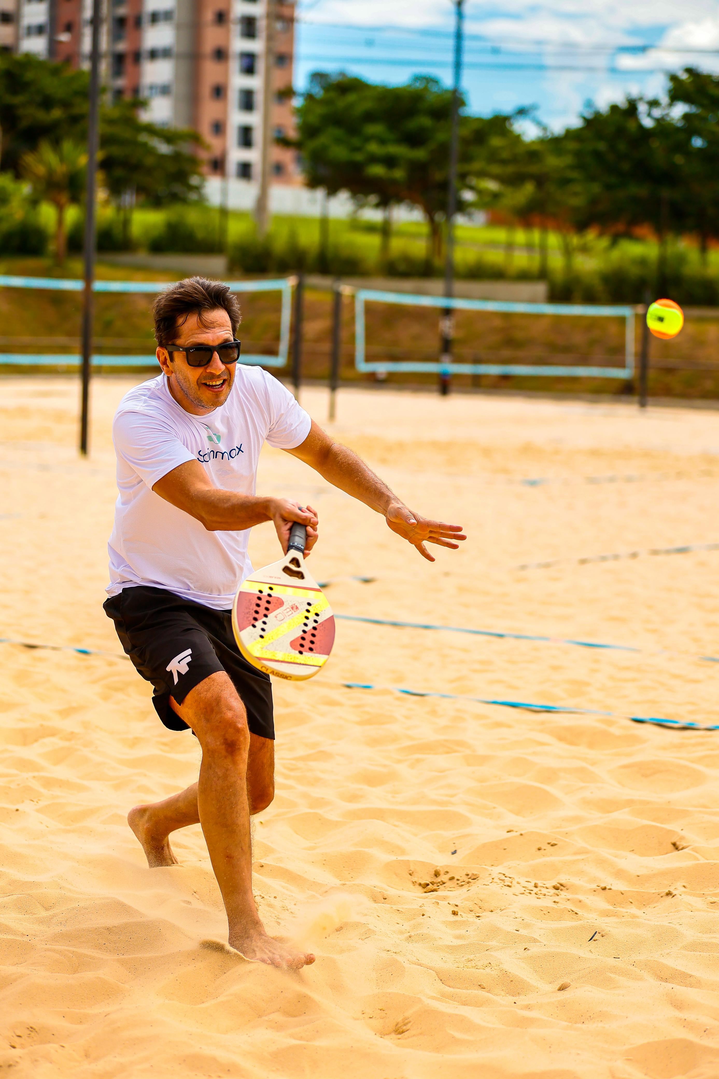 Beach tennis ação homem batendo bola #2