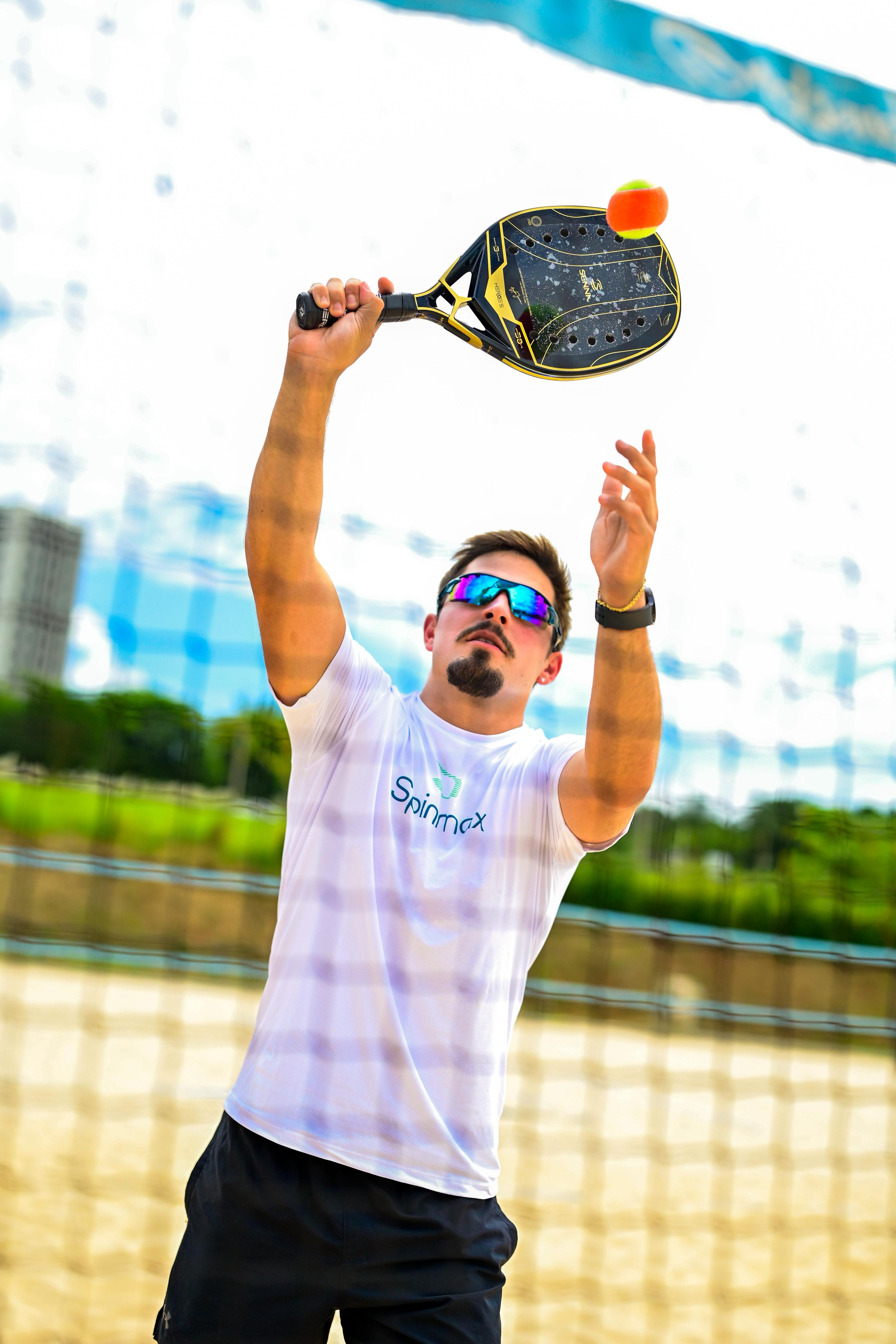 Beach tennis ação homem batendo bola